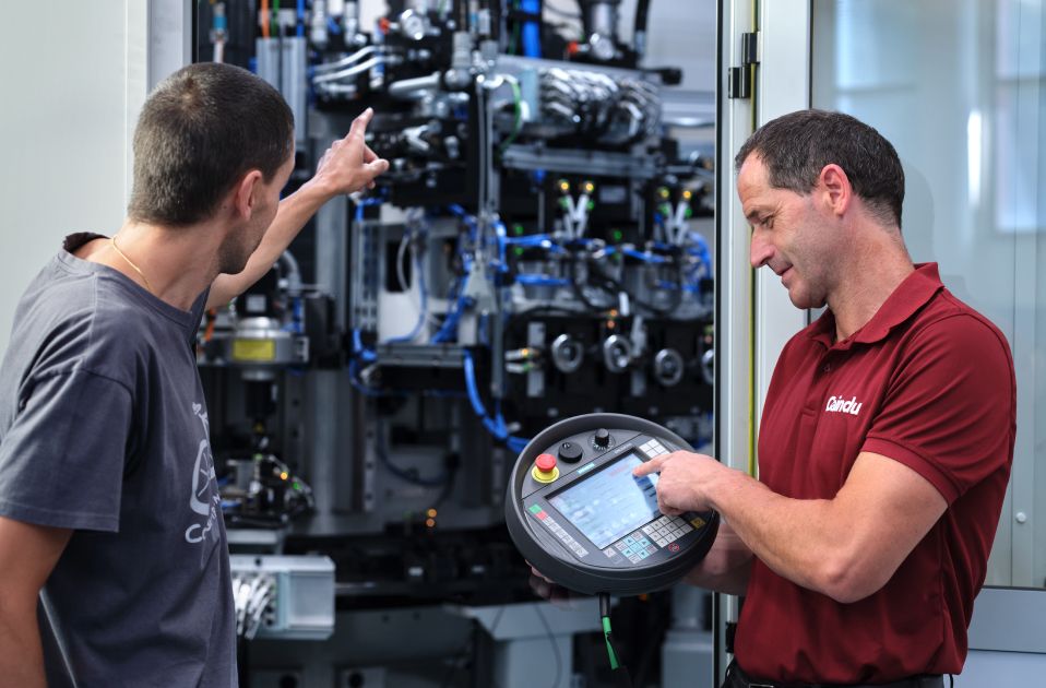 Assembly manager teaching the customer how to operate automated machines